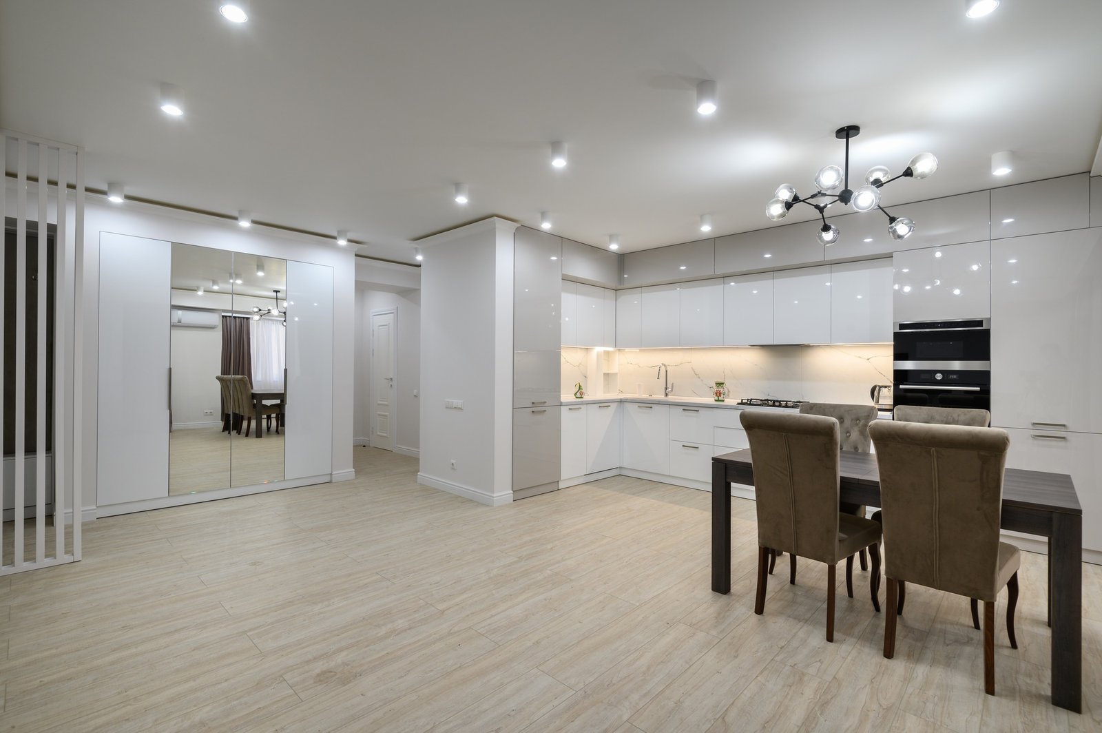 Interior of new spacious white kitchen after renovation in studio apartmen