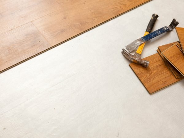 Hammer and Pry Bar with Laminate Flooring Abstract